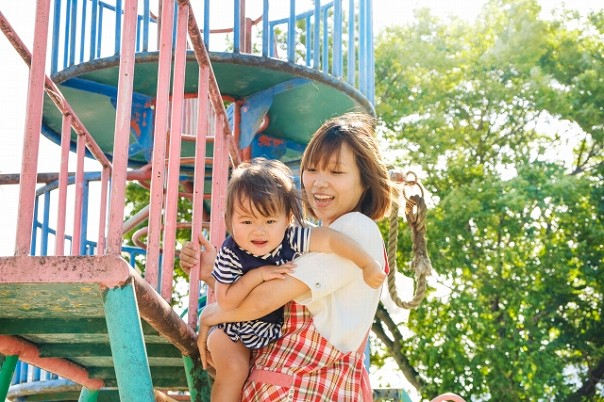 やんちゃな子供を守るエプロン姿の女性